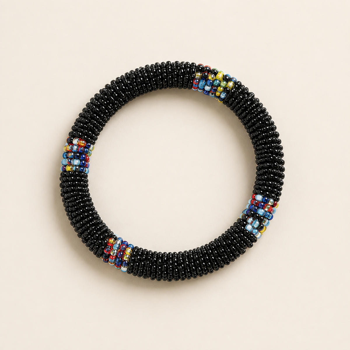 Black circular beaded bangle with multicoloured accents.