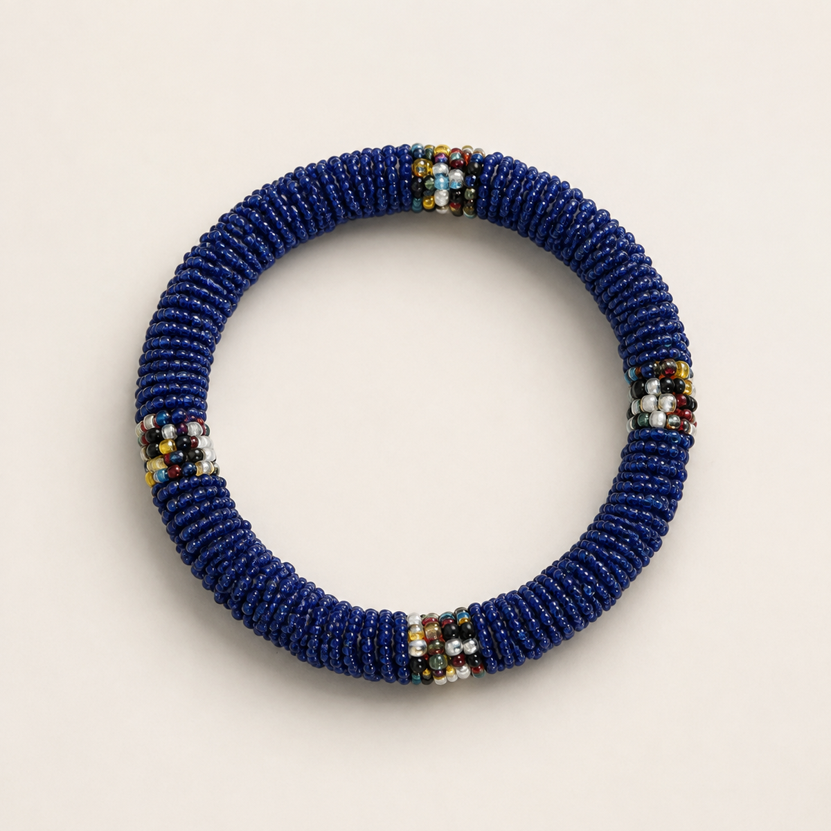 Blue circular beaded bangle with multicoloured accents.