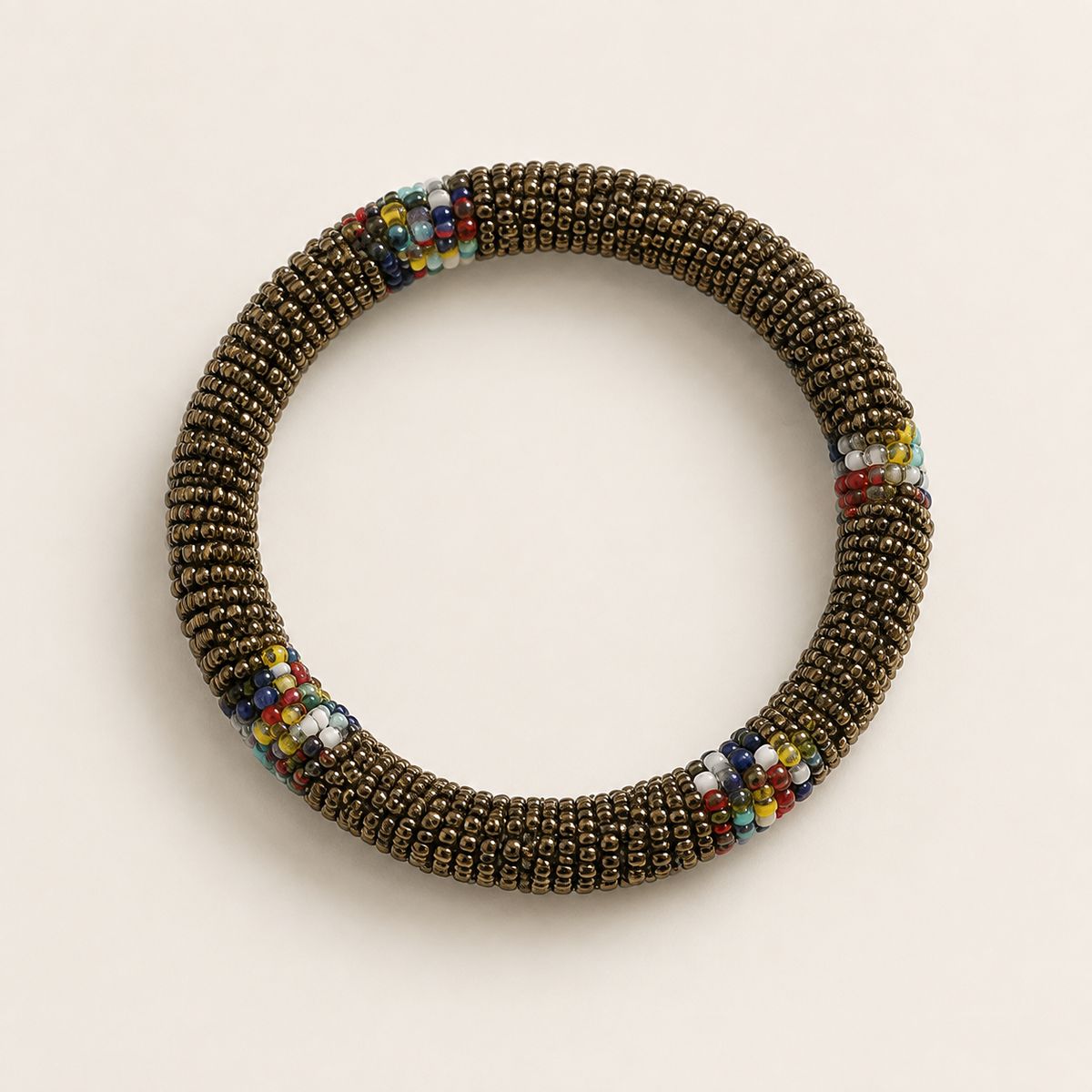 Bronze-coloured circular beaded bangle with multicoloured accents.