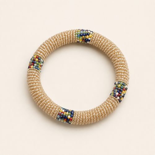 Cream circular beaded bangle with multicoloured accents.