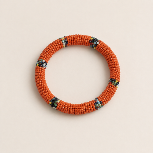 Orange circular beaded bangle with small multicoloured accents.