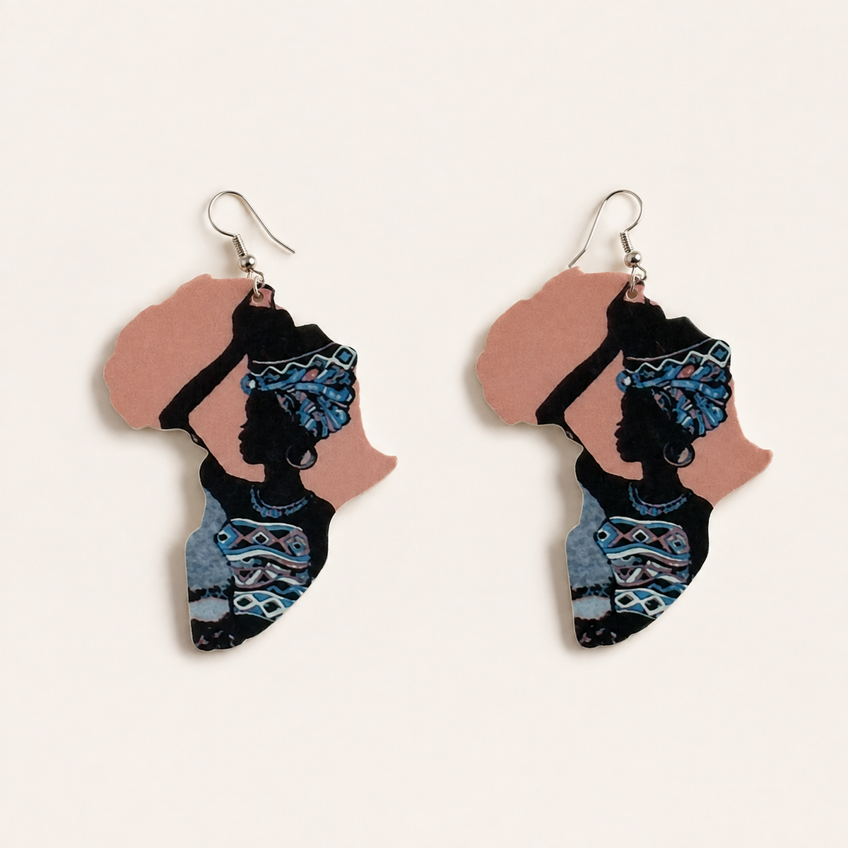 Pair of Africa-shaped wooden drop earrings with portrait artwork and blue details on a pink background.