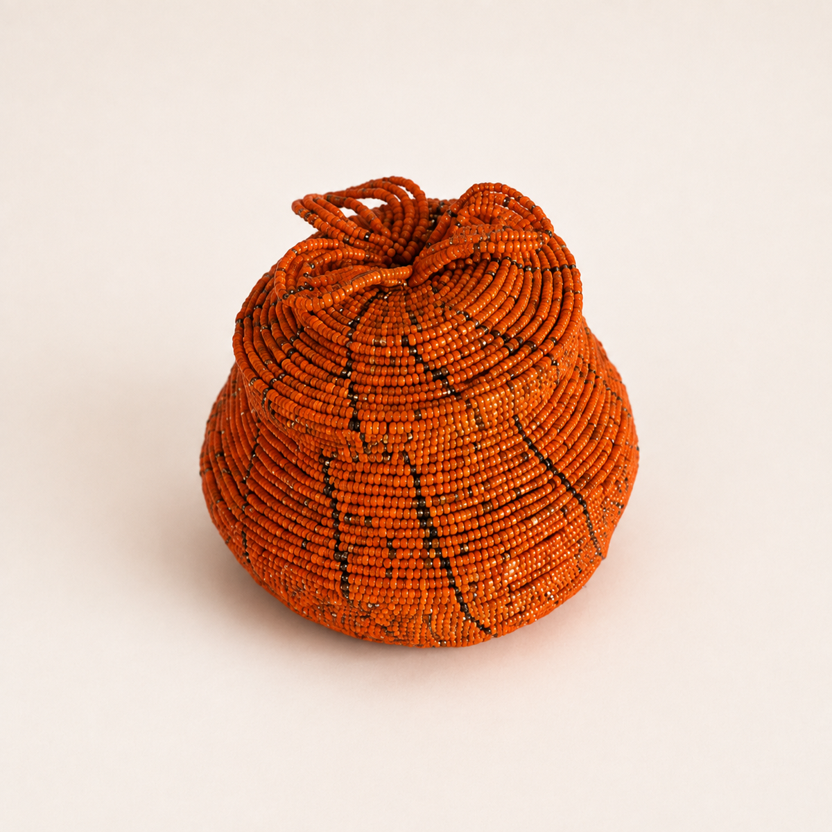 Orange hand-beaded jewellery box with a coordinating lid and raised floral beadwork.