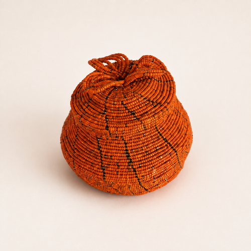 Orange hand-beaded jewellery box with a coordinating lid and raised floral beadwork.