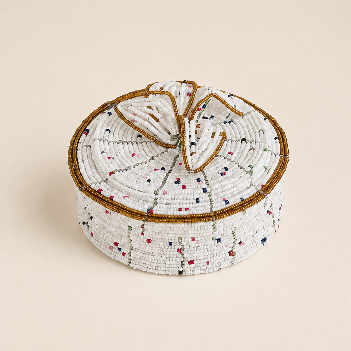White hand-beaded jewellery box with multicoloured accents, gold-coloured trim and a floral beaded lid.