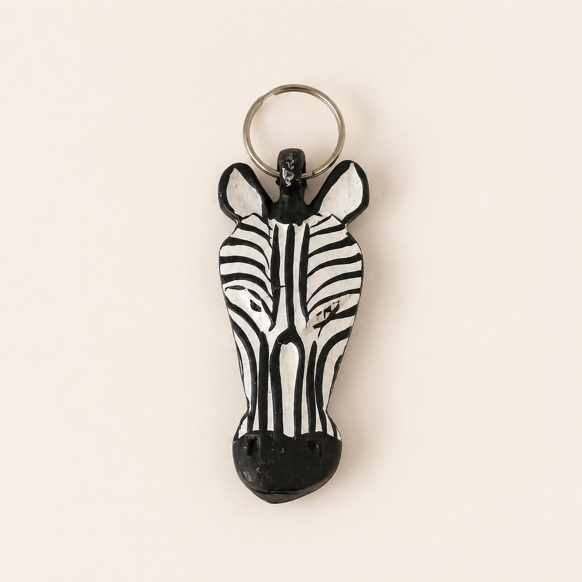 Hand-painted wooden zebra-head keyring with a metal split ring.