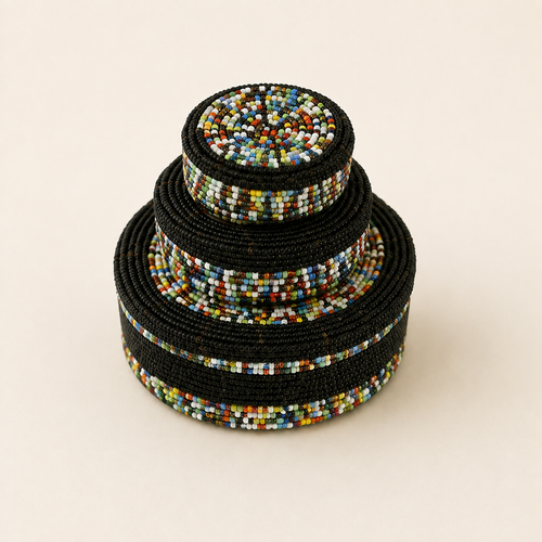 Set of three black hand-beaded nesting baskets with multicoloured bands.